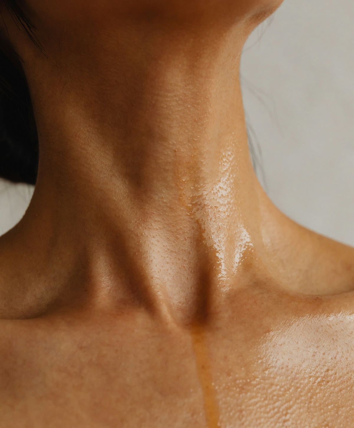 Close-up of glistening skin on neck.