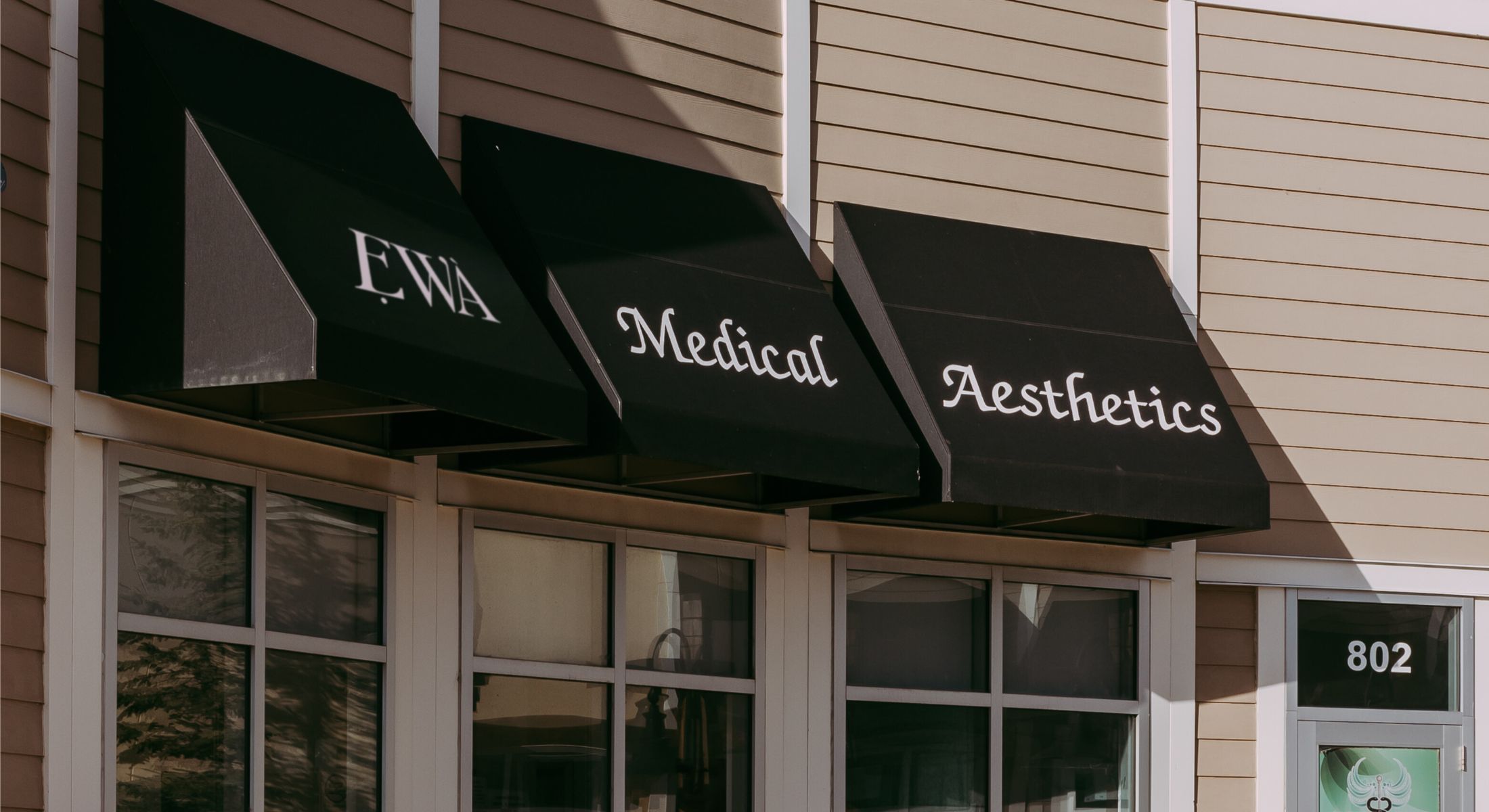 Medical aesthetics shop exterior sign detail.