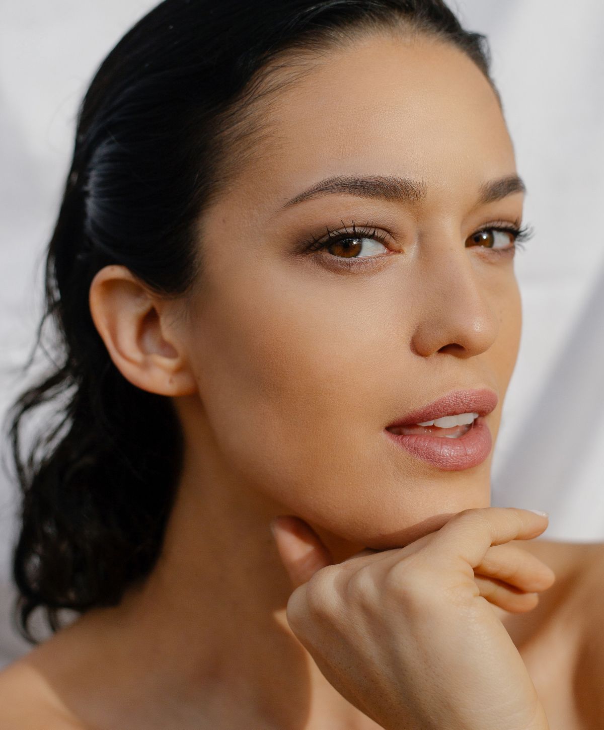 Close-up portrait of a woman with soft makeup.