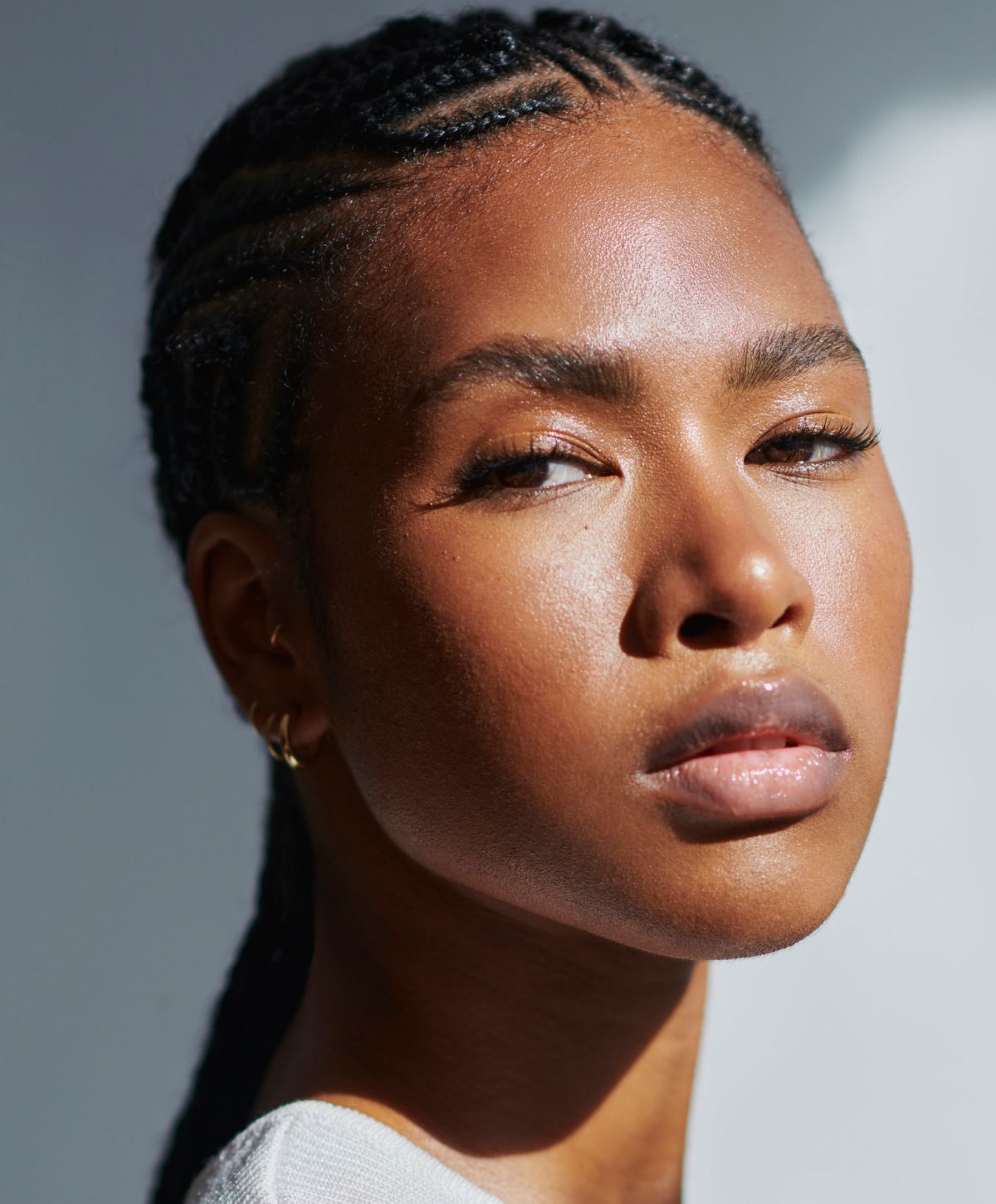 Close-up portrait of a person with braids.