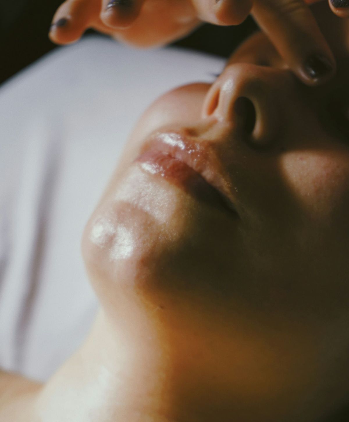 Person receiving a facial treatment close-up.